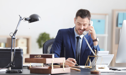 Young male notary working in office