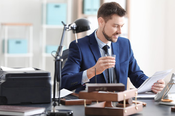 Young male notary working in office