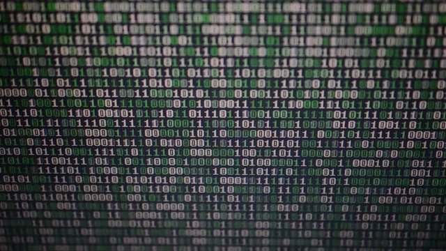 Binary code on the monitor screen.