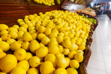 Store bazaar of fresh fruit. Yellow lemons and limes in boxes