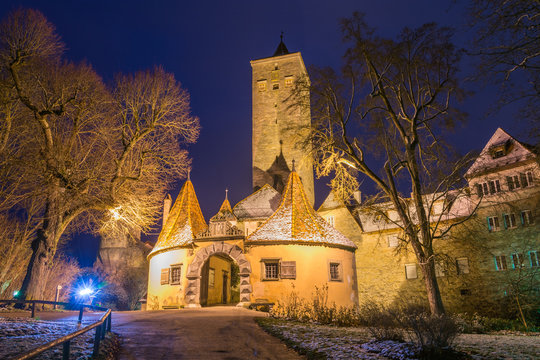The historic castle gate and tower in Rothenburg ob der Tauber, Germany at night