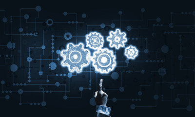 Glowing cogwheel mechanism icon on dark background as symbol of teamwork