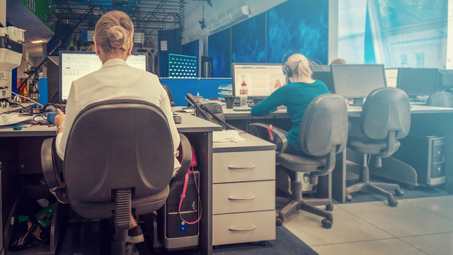 A journalist working on a computer in Newsroom