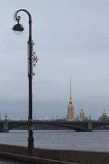 Russia, St. Petersburg, a lantern on the embankment on the background of the Trinity Bridge and the Peter and Paul Fortress