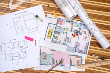Fototapeta premium plan of apartment rooms and blueprint rolls with work tolls