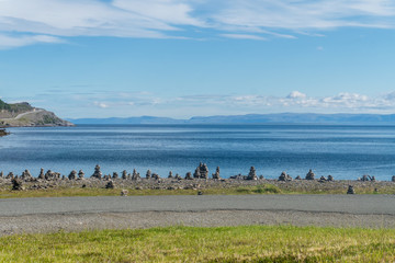 Naklejka premium Pyramids made of stones on the coast of Porsanger Fjord, Finnmark, Norway