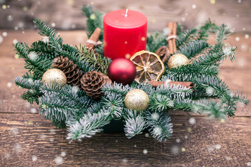 New year and Christmas still life illustration. Red candele, fir-tree branches, Christmas tree decorations on a wooden background.