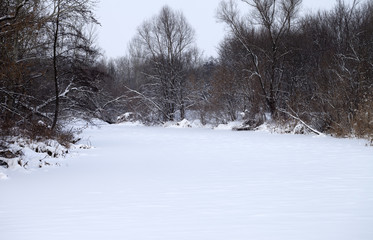 Frozen river covered with snow at winter