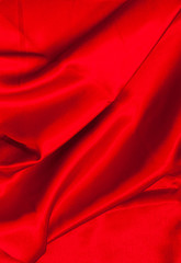 Smooth elegant red silk or satin luxury cloth texture can use as abstract background. Luxurious valentines day background design