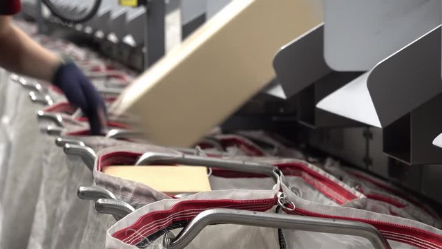 Staff working at the automated parcel sorting system filling bags