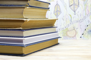 A heap of some very old and new books in the library in front of the blurred hand drawn doodle...