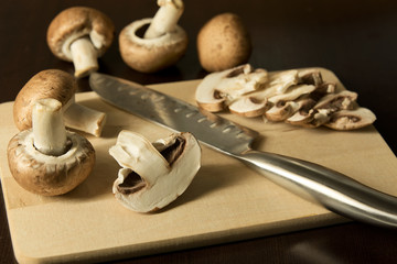 Studio shot of sliced brown mushrooms on cutting board