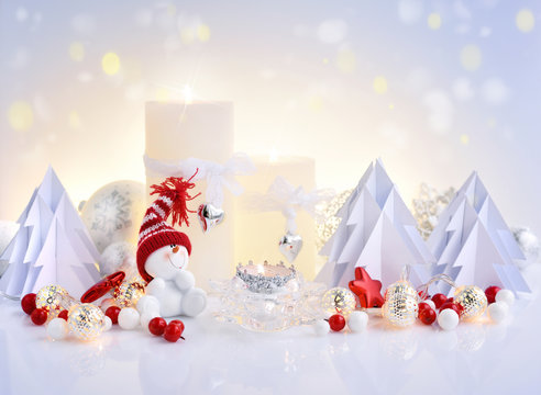 Christmas composition with candles, snowman and paper spruces. Christmas or New Year greeting card.