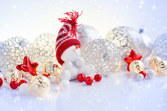 Christmas or New Year background with festive decorations. Snowman, christmas balls and lights.