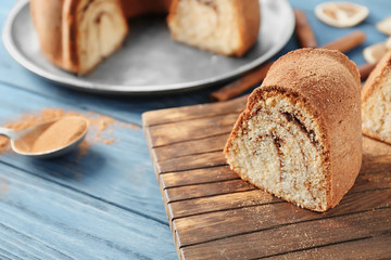 Delicious cinnamon roll cake on wooden board