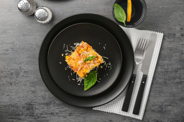Plate with piece of corn pudding on table, top view
