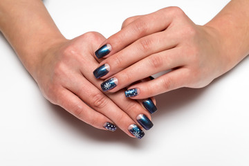 Obraz na płótnie Canvas Winter blue manicure with snowflakes on long square nails 