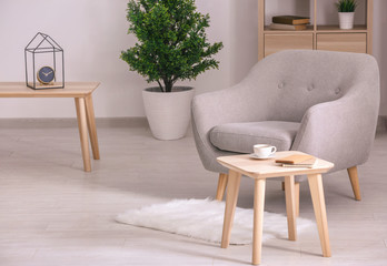Elegant interior of living room with comfortable armchair