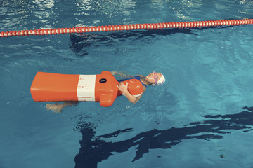 School Girl in a Pool Rescue Training Dummy