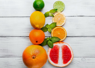 Citrus and mint on white wooden background.Lime,lemon,grapefruit