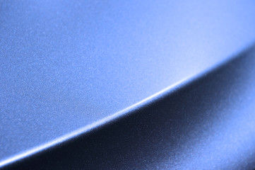 Fragment of blue steel car bodywork, vehicle silver paint coating texture, selective focus,...