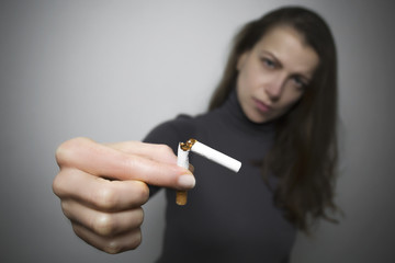 Woman with a cigarette. The concept of harm from smoking.