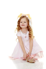 Little girl trying on shoes.