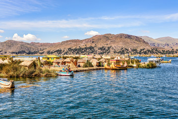 Floating islands made from reeds on Lake Titicaca under blue ski