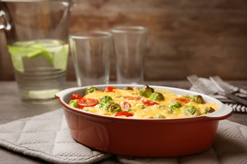 Baking dish with Brussels sprouts and cheese on table