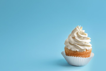 Tasty cupcake on color background