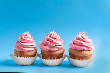 Tasty cupcakes on color background