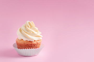 Tasty cupcake on color background