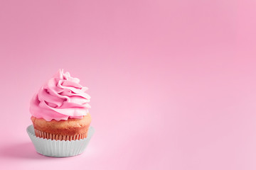 Tasty cupcake on color background