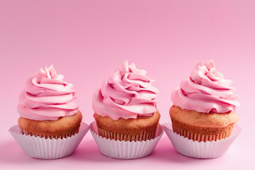 Tasty cupcakes on color background
