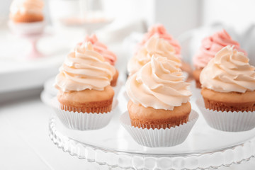 Tasty cupcakes on stand