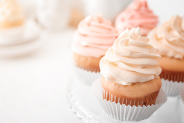 Tasty cupcakes on stand