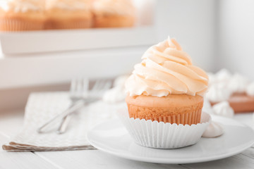 Tasty cupcake on plate