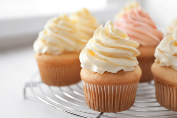 Tasty cupcakes on cooling rack