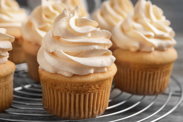 Tasty cupcakes on cooling rack