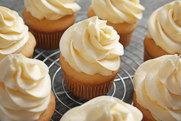Tasty cupcakes on cooling rack
