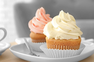 Tasty cupcakes on plate