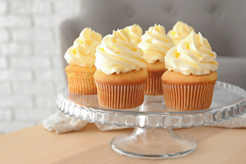 Tasty cupcakes on stand