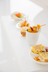 Sortiment of different appetizers ( salmon, soup, vegetable skewer,...)