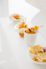 Sortiment of different appetizers ( salmon, soup, vegetable skewer,...)