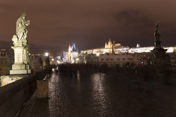 Obraz premium Night colorful snowy Christmas Prague Lesser Town with gothic Castle from Charles Bridge, Czech republic