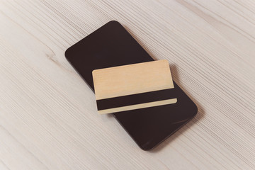 closeup phone and credit card on table.