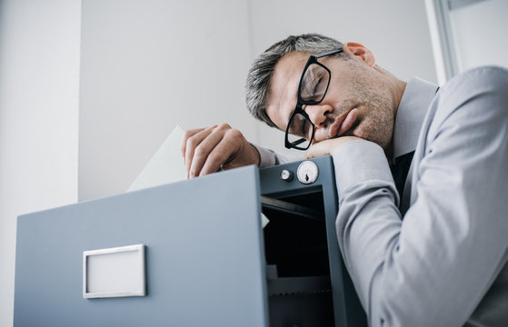 Tired office worker sleeping in the office