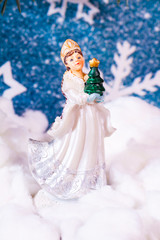 Fototapeta na wymiar New Year's background on a background of a New Year tree Snow Maiden toy