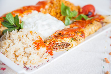 Turkish dish with rolled kebap meat and rice