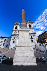 Sallustian Obelisk (Italian: Obelisco Sallustiano) on the top of the Spanish Steps in Rome, Italy. Frontal view. Blue sky. Nobody